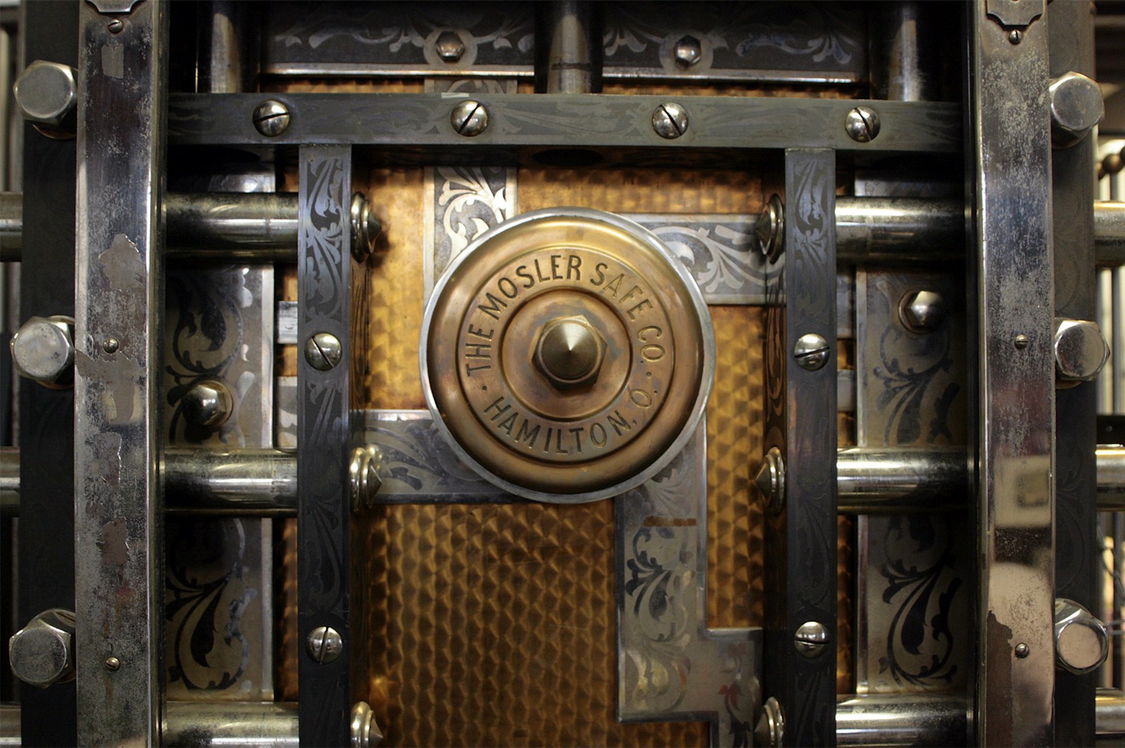 Close-up of a bank vault door and its locking mechanism.
